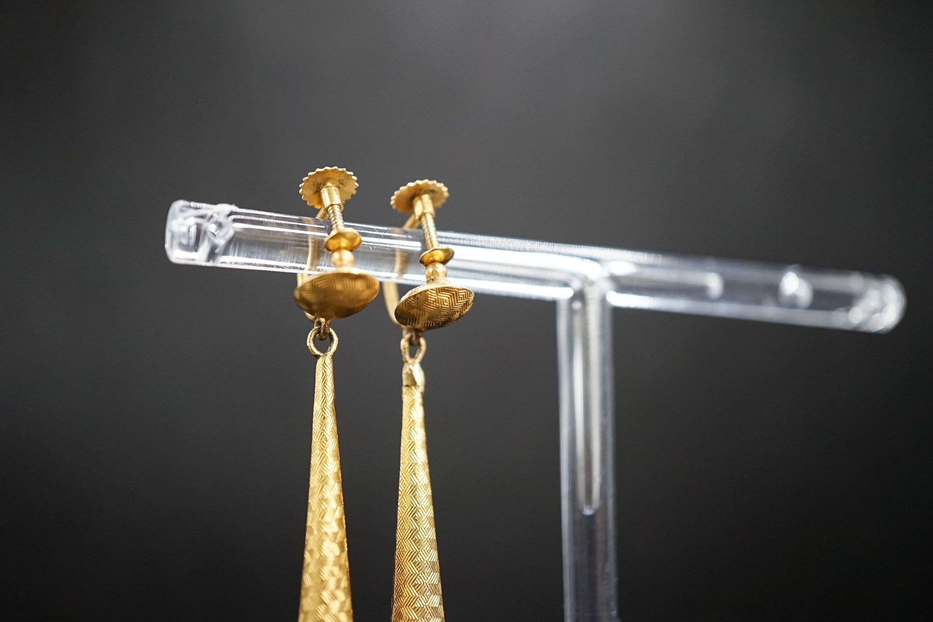 A pair of hollow, yellow metal teardrop shaped earrings, (a.f.), 6cm, 3.3 grams.